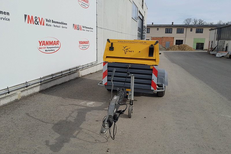 Frontansicht des Atlas Copco Stromerzeugers QAX 40 auf Anhänger mit robuster Bauweise für den zuverlässigen Einsatz als mobiler Baustromerzeuger.